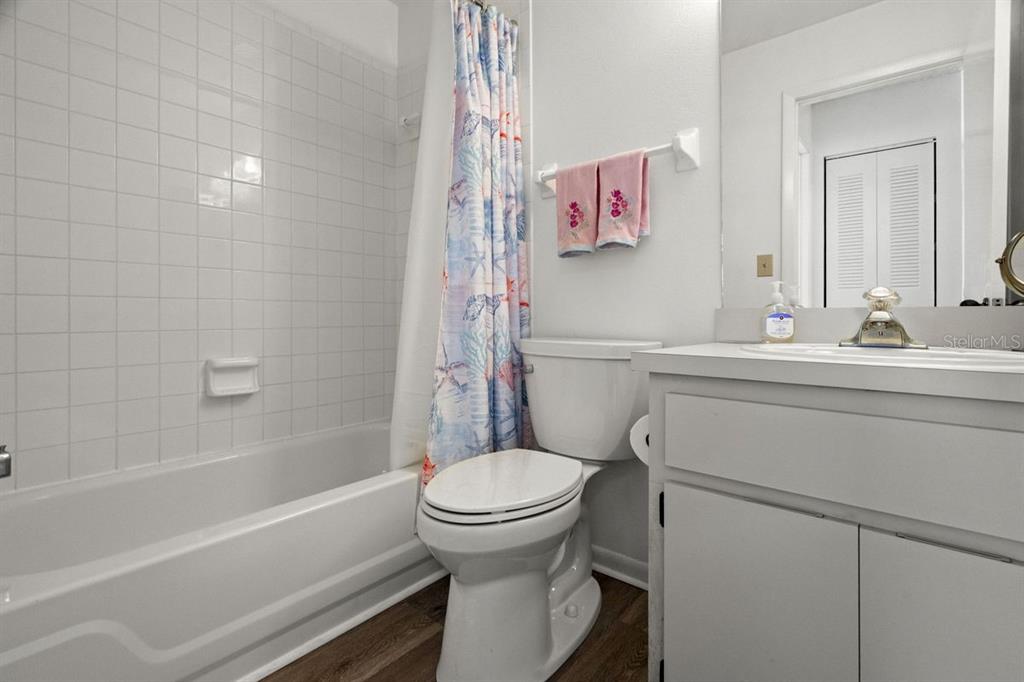 1438 Millstream Lane, Unit 203 Dunedin, FL 34698 - Photo 25 of 60 a bathroom with a sink toilet vanity and tub