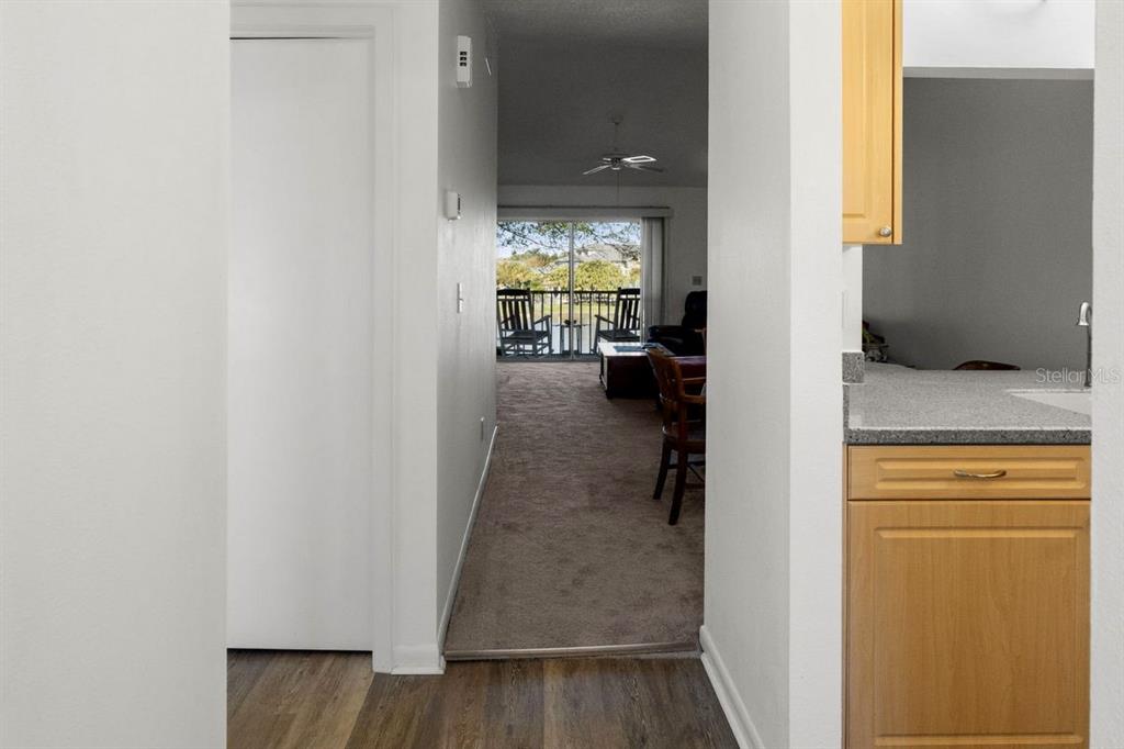 1438 Millstream Lane, Unit 203 Dunedin, FL 34698 - Photo 26 of 60 a view of hallway with livingroom and furniture