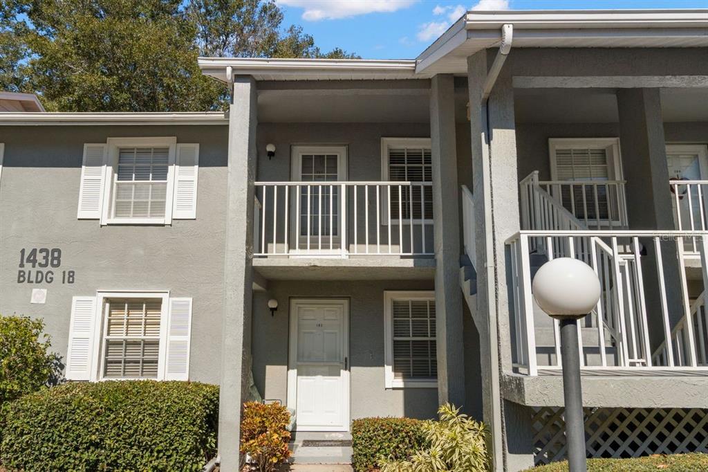 1438 Millstream Lane, Unit 203 Dunedin, FL 34698 - Photo 29 of 60 a outdoor view of a house with a porch