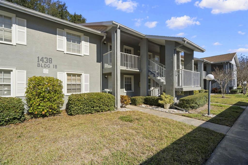 1438 Millstream Lane, Unit 203 Dunedin, FL 34698 - Photo 30 of 60 a front view of a house with garden