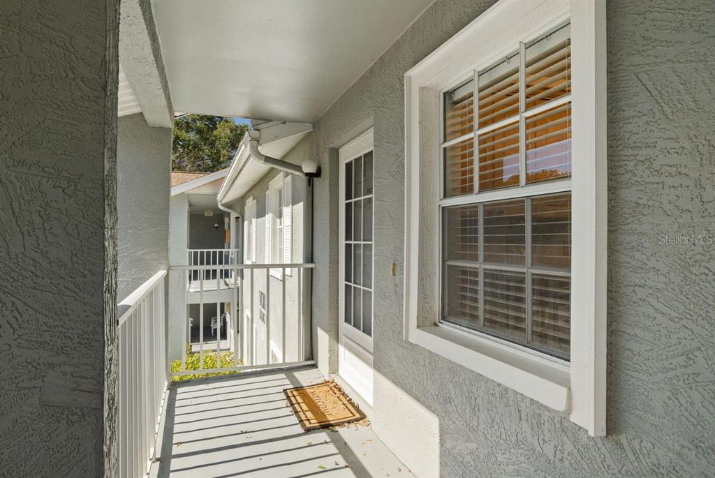 1438 Millstream Lane, Unit 203 Dunedin, FL 34698 - Photo 6 of 60 a view of a house with a door and wooden floor
