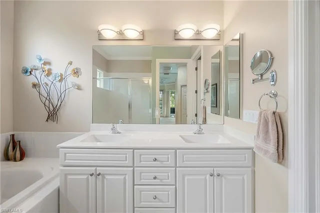 a bathroom with a bathtub a sink and a window