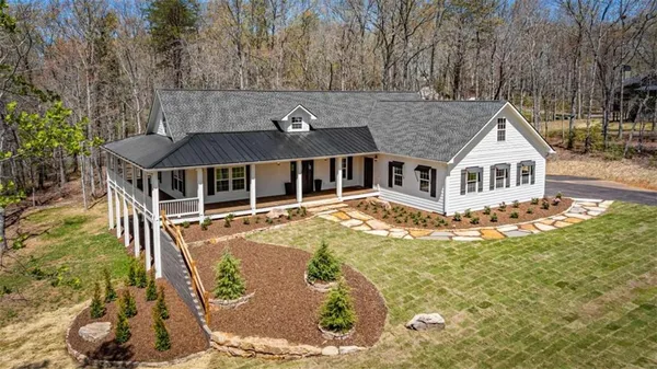 a aerial view of a house with a yard