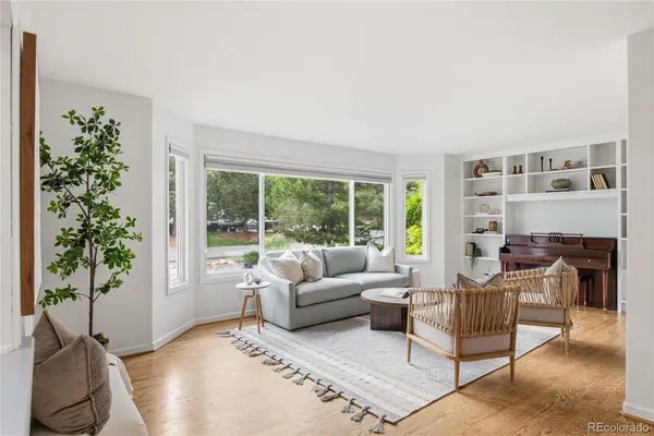 a living room with furniture and a potted plant