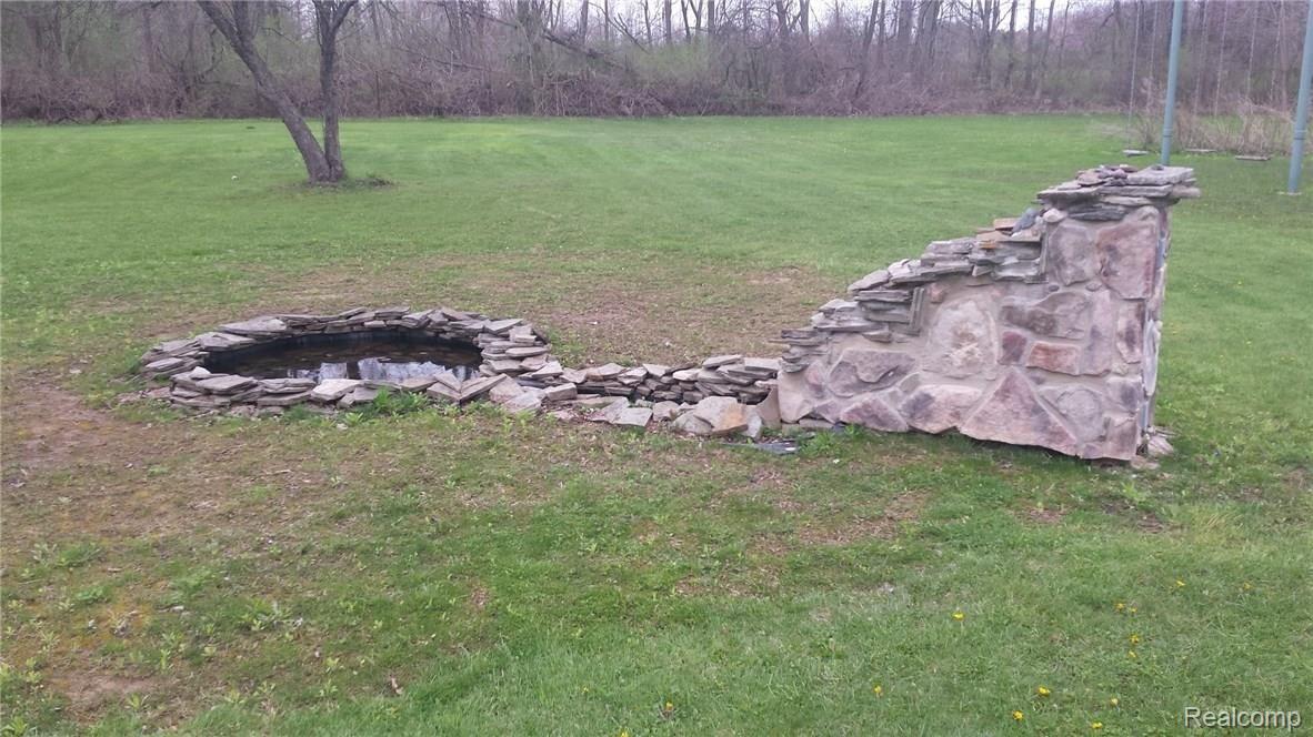 9772 Bryce Road Avoca, MI 48006 - Photo 20 of 26 This is a view of the fountain in the yard.