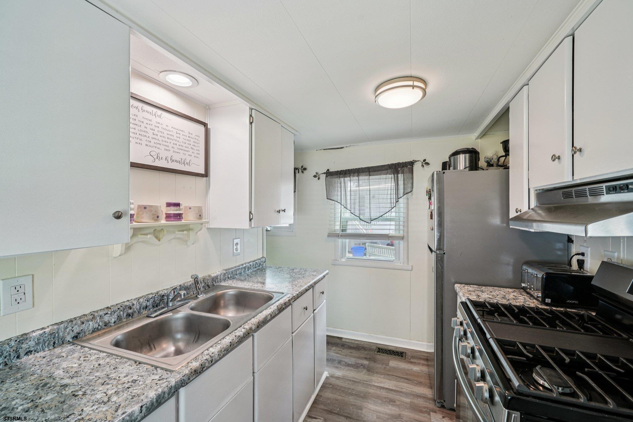 2528 Tilton Road Egg Harbor Township, NJ 08234 - Photo 13 of 31 a kitchen that has a sink and a stove
