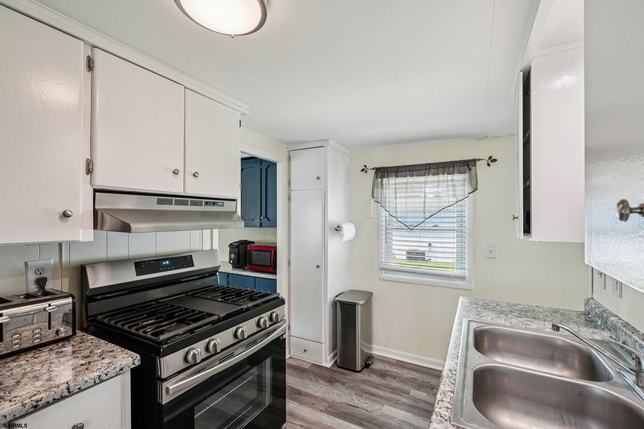 2528 Tilton Road Egg Harbor Township, NJ 08234 - Photo 15 of 31 a kitchen with granite countertop a stove and a sink