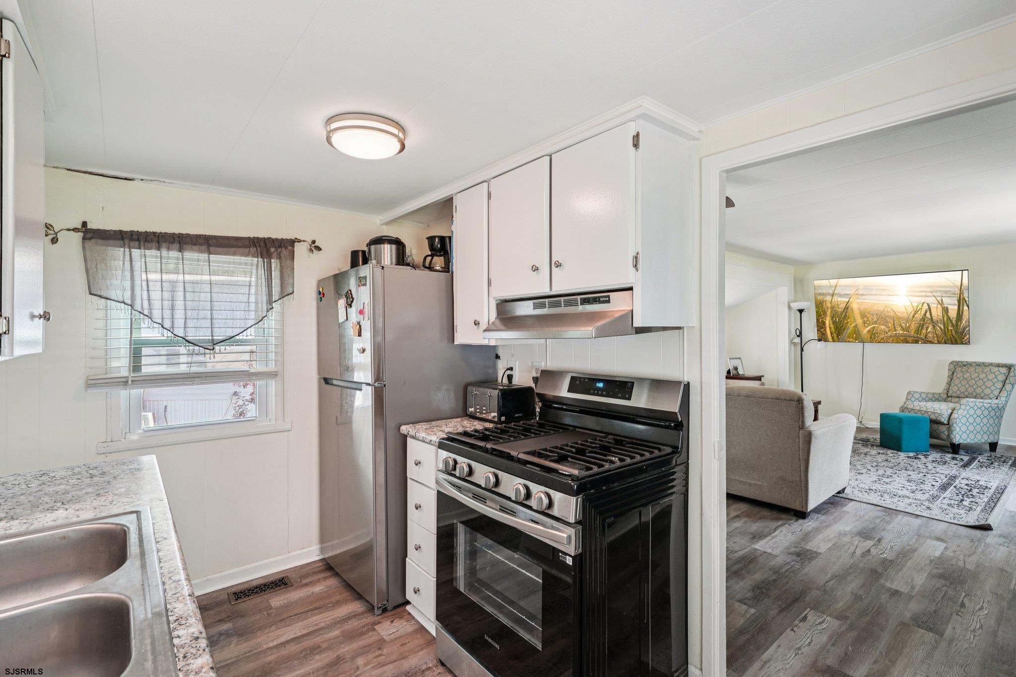 2528 Tilton Road Egg Harbor Township, NJ 08234 - Photo 16 of 31 a kitchen with a stove a refrigerator and a sink