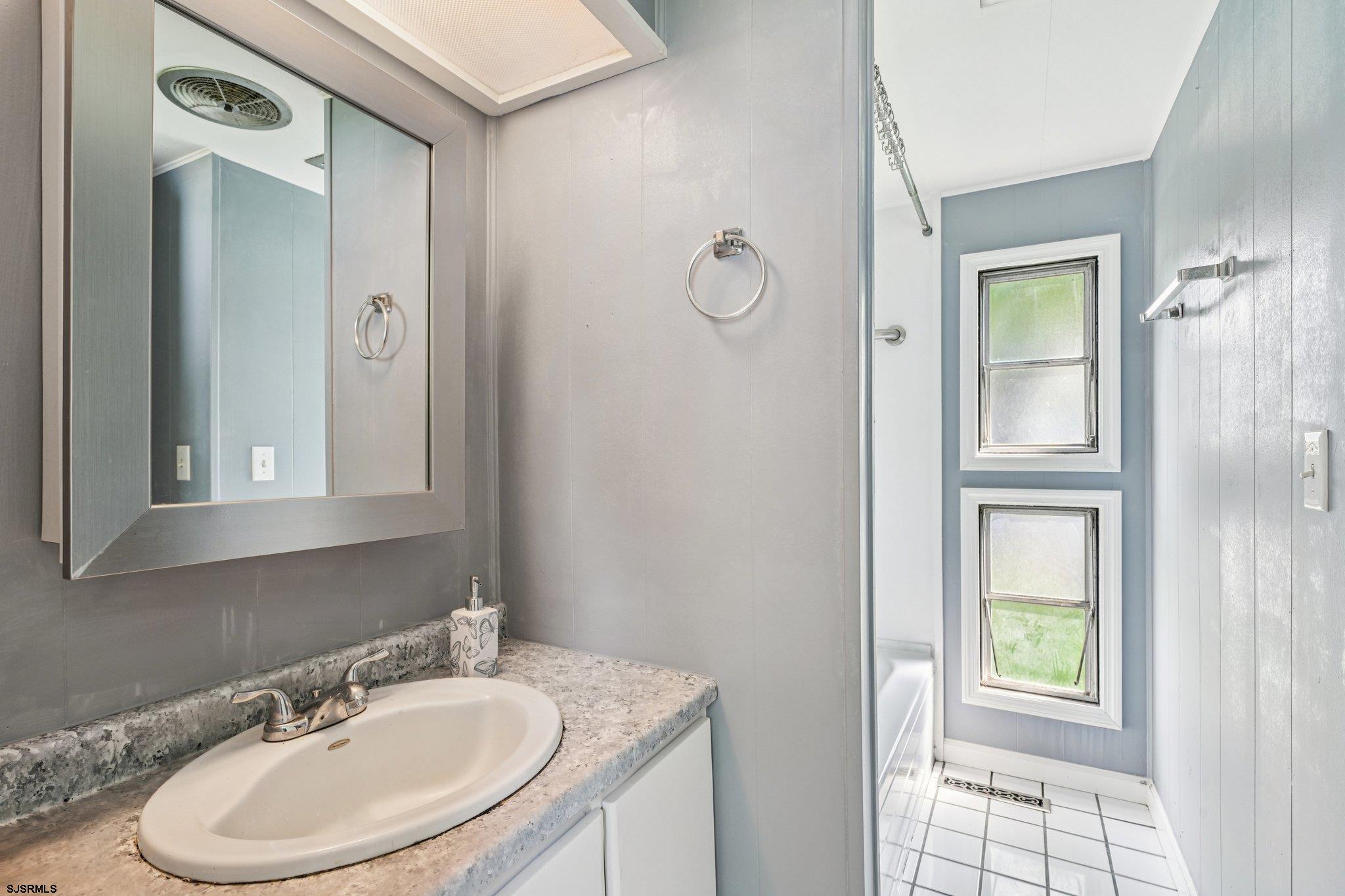 2528 Tilton Road Egg Harbor Township, NJ 08234 - Photo 23 of 31 a bathroom with a sink a toilet and a mirror
