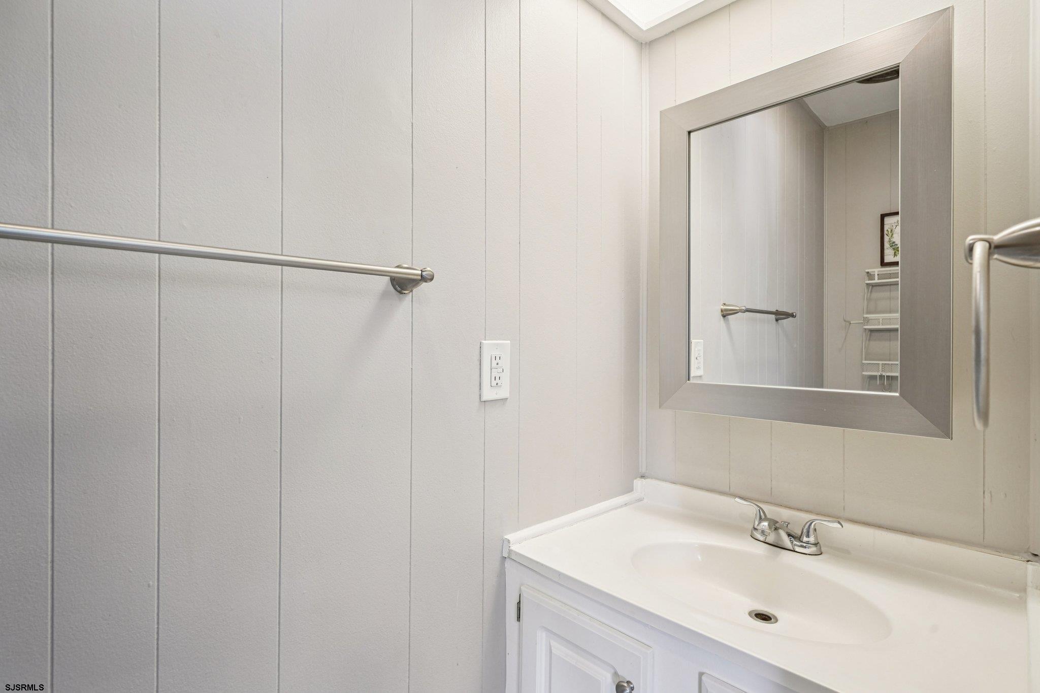 2528 Tilton Road Egg Harbor Township, NJ 08234 - Photo 28 of 31 a bathroom with a sink a mirror and shower