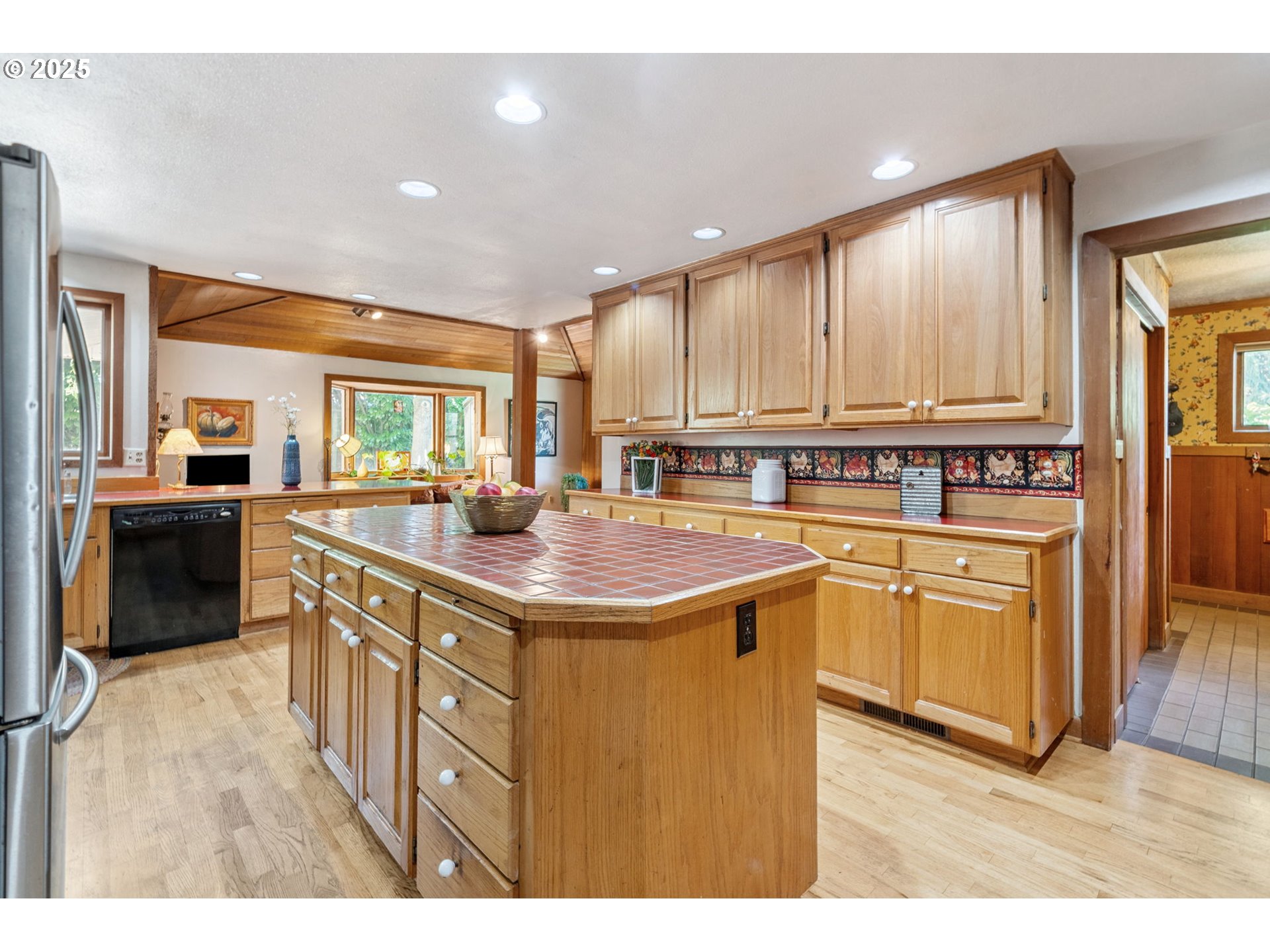 12040 Southeast Revenue Road Boring, OR 97009 - Photo 11 of 46 a kitchen with kitchen island granite countertop a stove top oven a sink a dining table and chairs