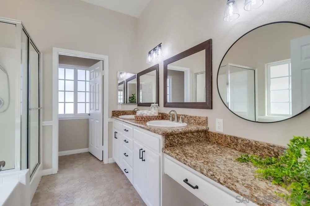8837 Diamondback Drive Santee, CA 92071 - Photo 18 of 37 a bathroom with a granite countertop sink mirror and vanity