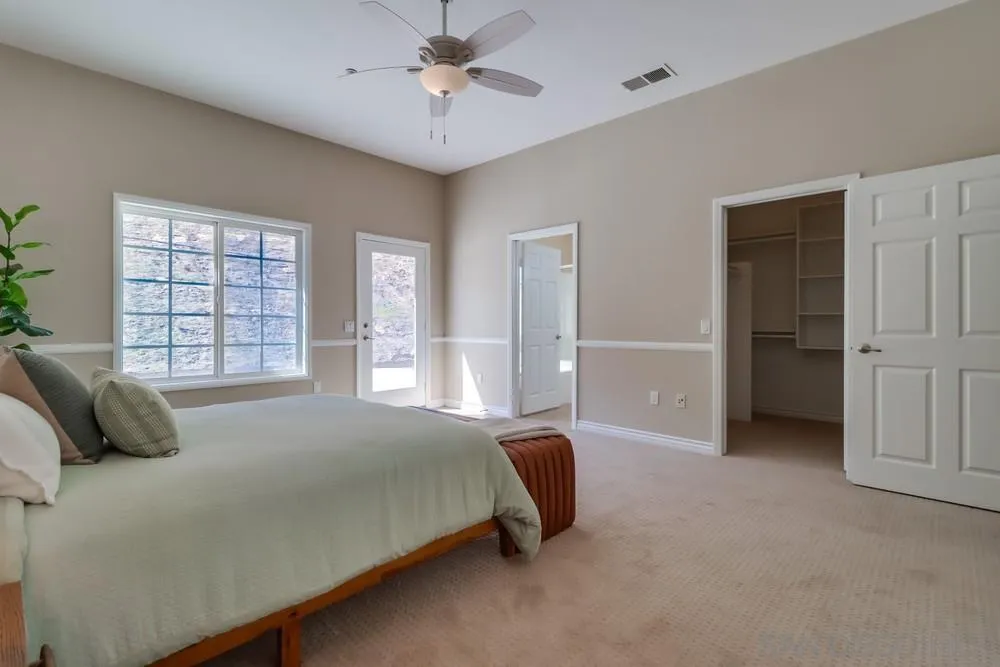 8837 Diamondback Drive Santee, CA 92071 - Photo 19 of 37 a bedroom with a bed and a large window