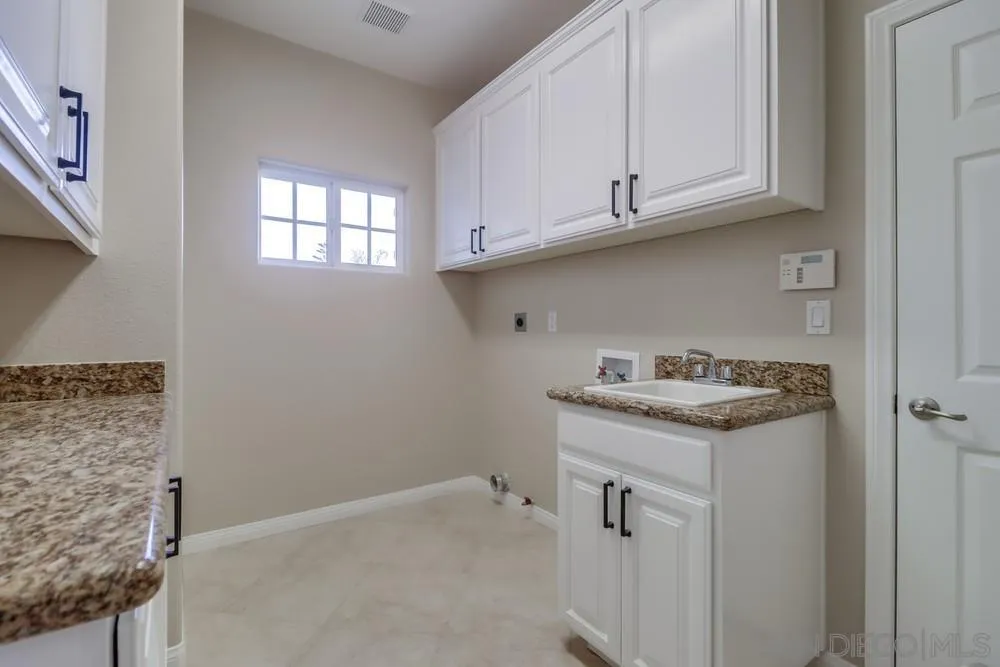 8837 Diamondback Drive Santee, CA 92071 - Photo 25 of 37 a utility room with cabinets washer and dryer