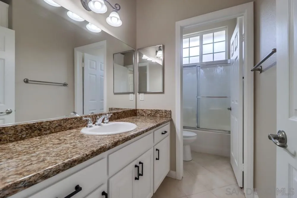 8837 Diamondback Drive Santee, CA 92071 - Photo 26 of 37 a bathroom with a granite countertop sink toilet and shower