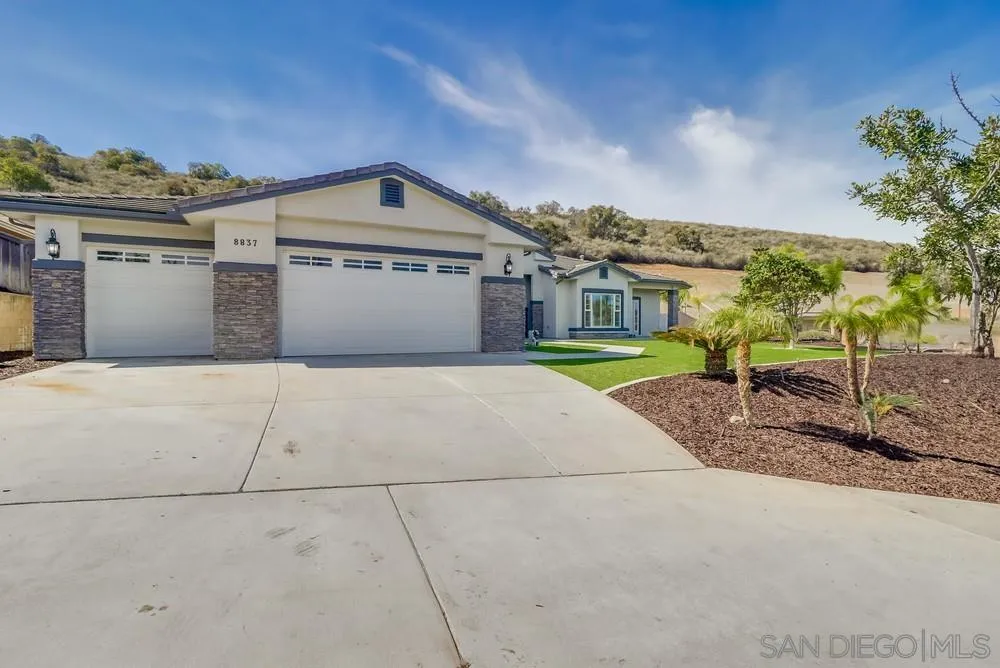 8837 Diamondback Drive Santee, CA 92071 - Photo 34 of 37 a front view of a house with a yard and garage