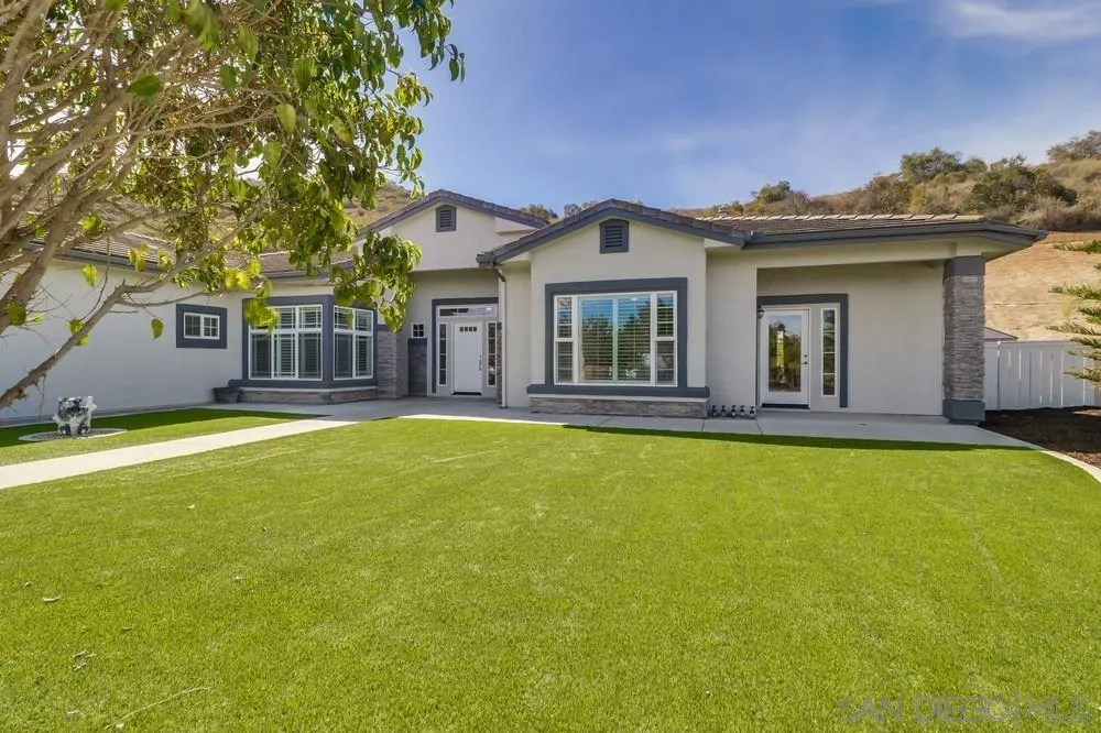 8837 Diamondback Drive Santee, CA 92071 - Photo 37 of 37 a front view of a house with swimming pool and glass windows