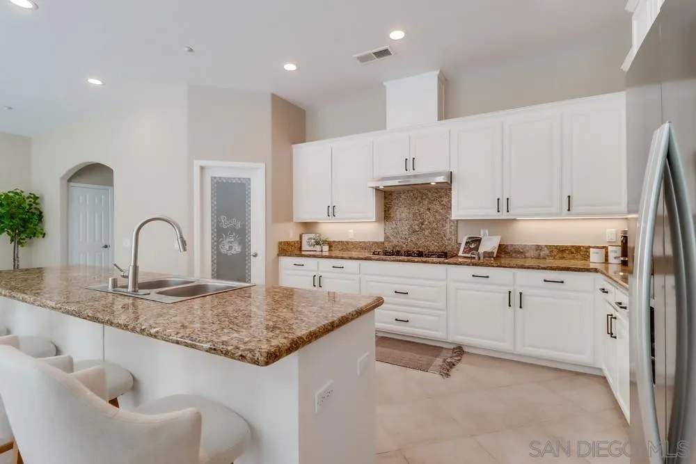 8837 Diamondback Drive Santee, CA 92071 - Photo 7 of 37 a kitchen with granite countertop white cabinets and sink