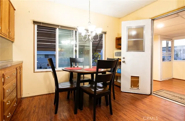 a dining room with furniture and wooden floor