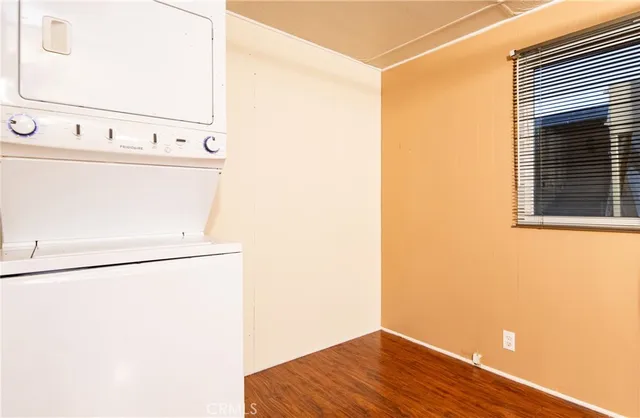 a view of a refrigerator in kitchen and a window