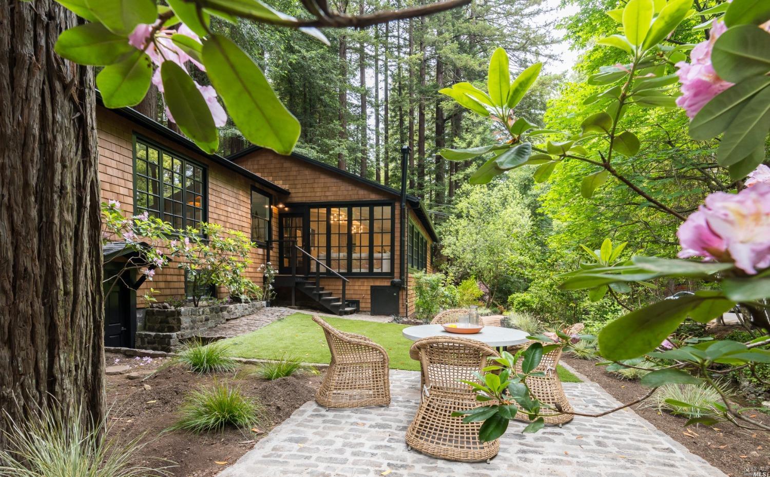 a view of a chair and table in backyard