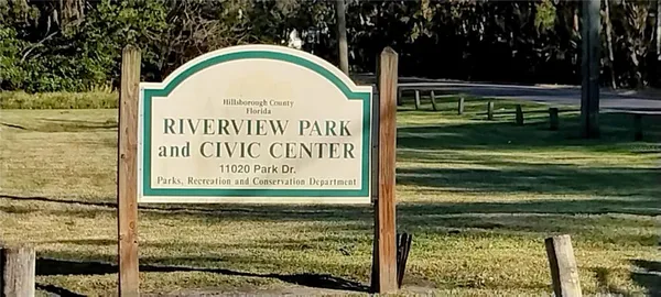 a swimming pool with lots of tress in the background