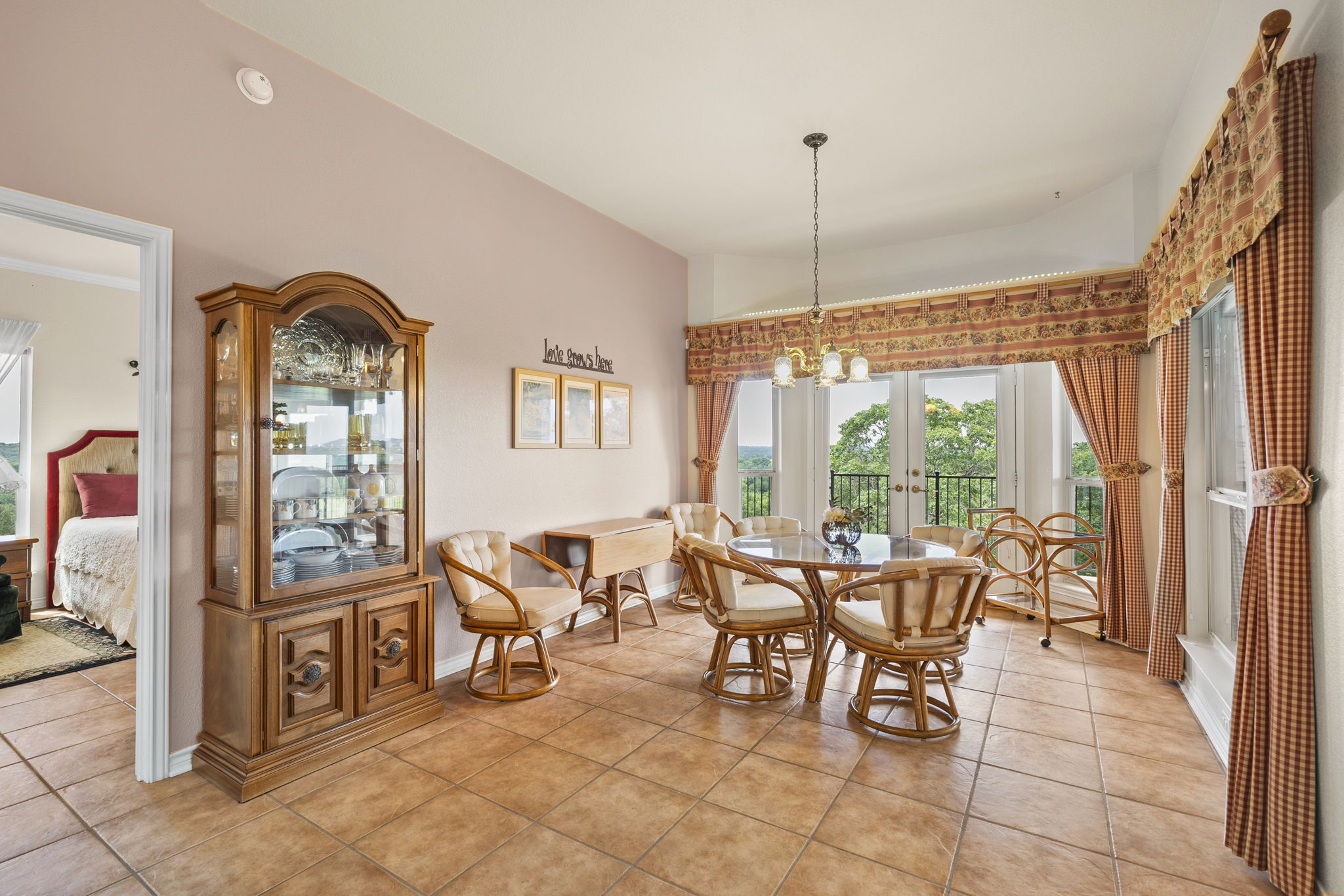 1427 River Ridge Ranch Road Killeen, TX 76549 - Photo 8 of 40 Terracotta tile floors flow through this dining area, featuring a decorative chandelier and covered patio access.
