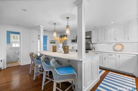 a kitchen with a table chairs refrigerator and cabinets