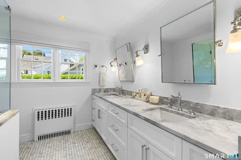 a view of a hallway with wooden floor and cabinet