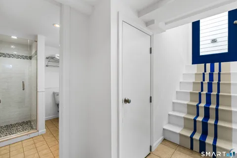 a view of a chair and tables in the balcony