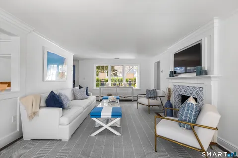 a living room with furniture fireplace and a flat screen tv