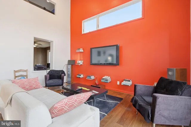 a living room with patio furniture and a fireplace