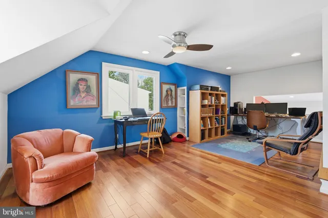 a workspace with furniture bookshelf and a window