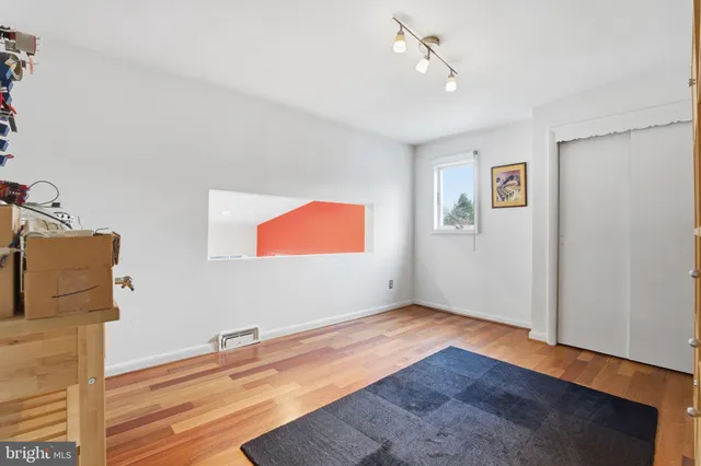 a spacious bedroom with a bed and cabinets
