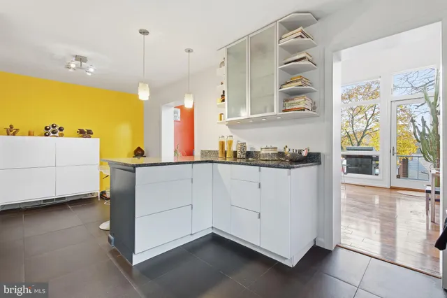 a kitchen with stainless steel appliances granite countertop a sink a stove and a wooden floors