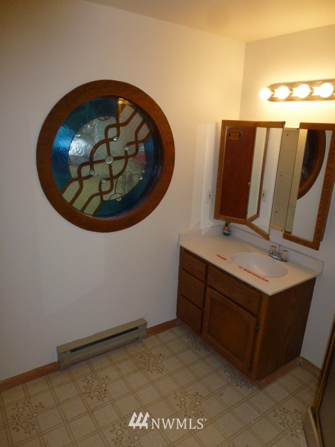 7115 Morgan Road Everett, WA 98203 - Photo 11 of 13 a bathroom with a sink and a mirror