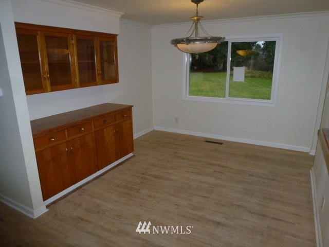 7115 Morgan Road Everett, WA 98203 - Photo 7 of 13 a view of an empty room with window and wooden floor
