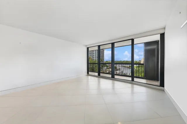 an empty room with sliding glass door and mountain view