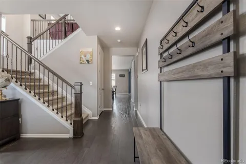 a view of a hallway with wooden floor and entryway