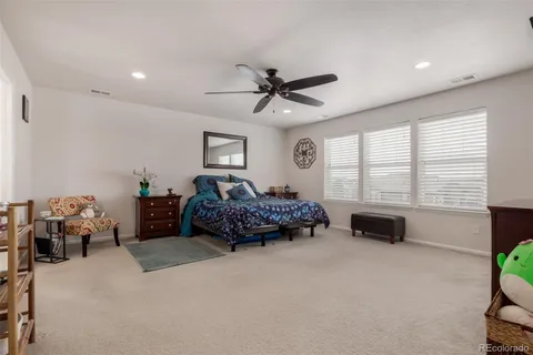 a bedroom with furniture and a large window