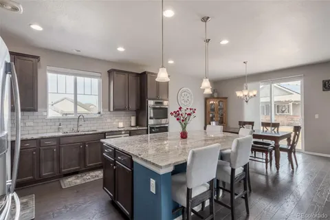 a kitchen with center island table and chairs in it