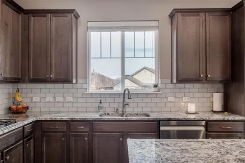 a kitchen with stainless steel appliances wooden cabinets and a sink