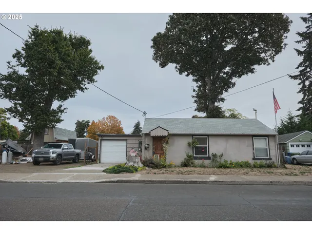 a view of a town with cars parked on the roadside