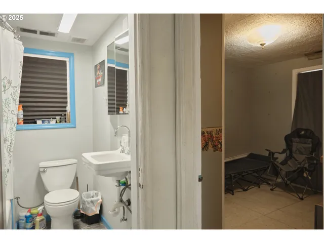 a bathroom with a toilet a sink and a mirror