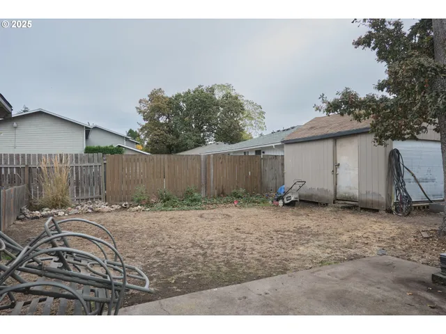 a backyard of a house with table and chairs