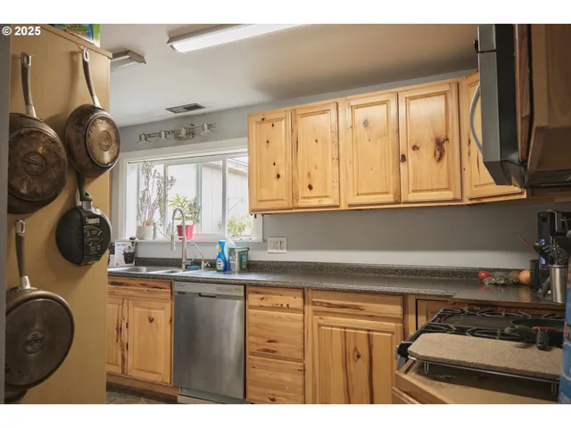 a kitchen with a sink a stove and cabinets