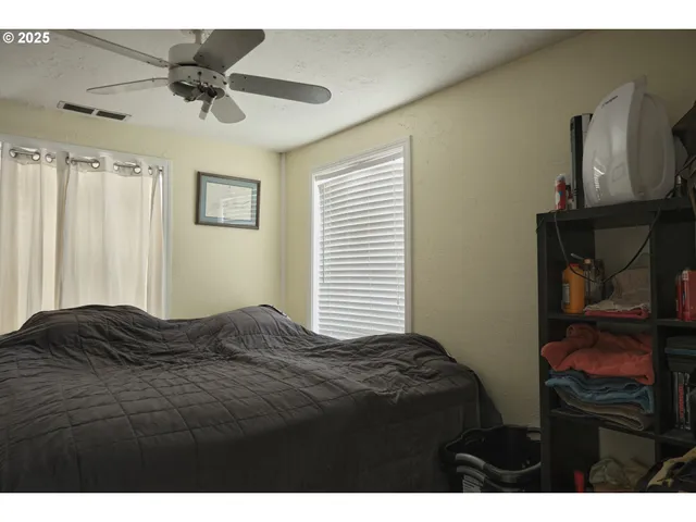 a bedroom with a bed and a television