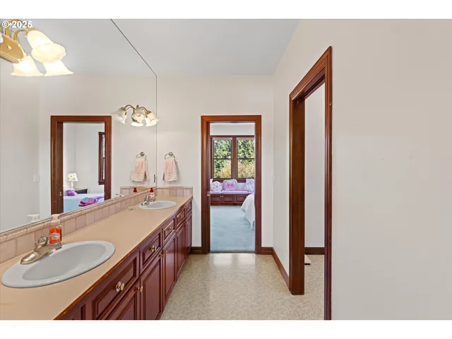 a bathroom with a sink a vanity and a mirror