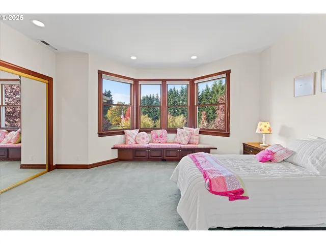 a bedroom with bed and glass windows