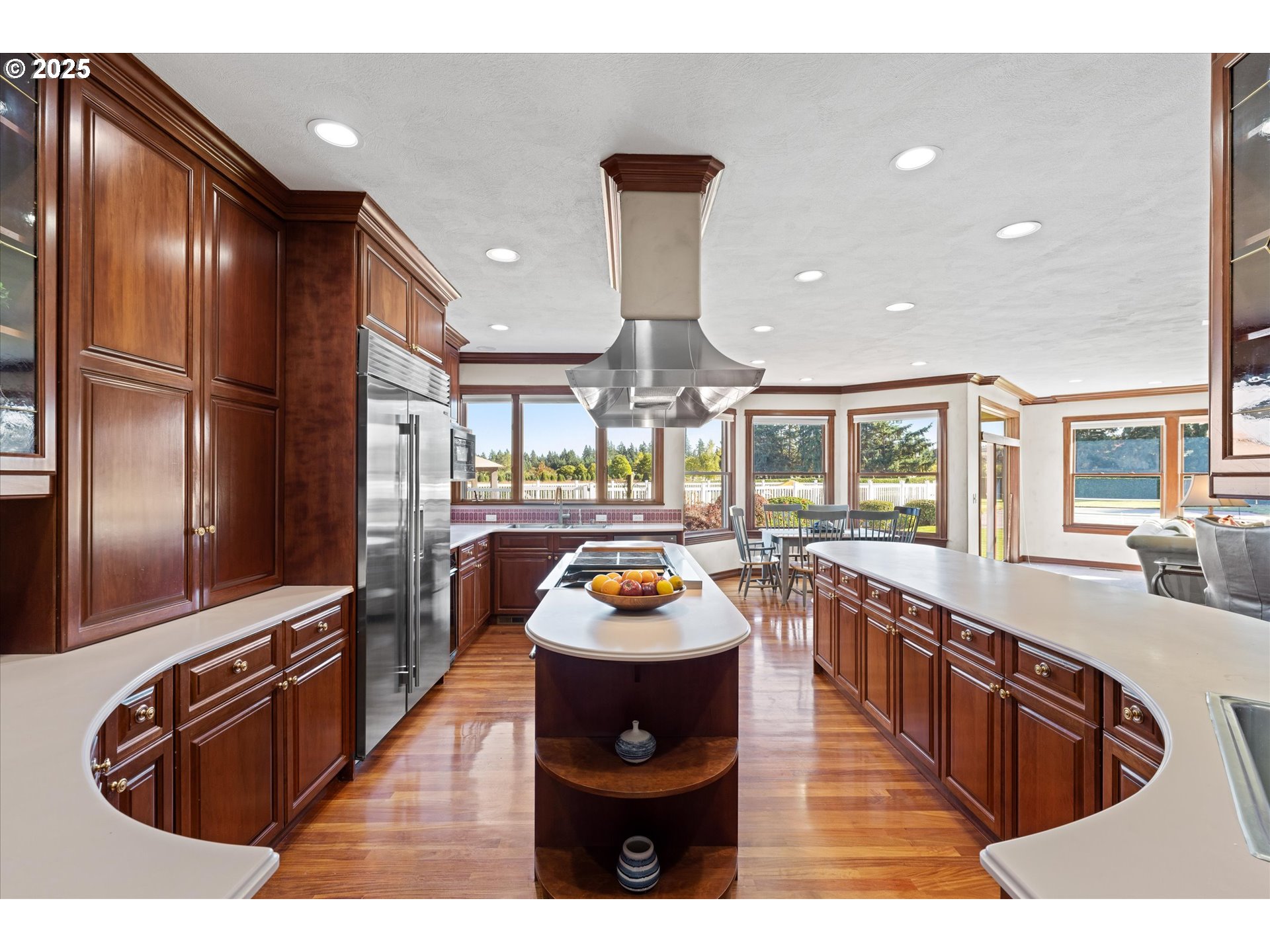 13680 Southwest Morgan Road Sherwood, OR 97140 - Photo 26 of 48 a kitchen with stainless steel appliances granite countertop a refrigerator a stove and a sink with wooden floor